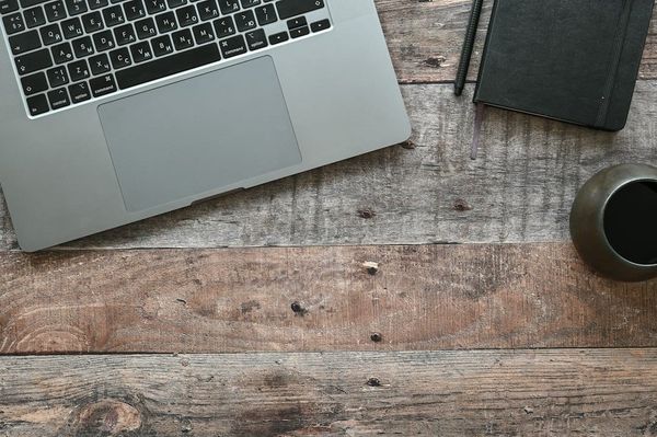 Minimal workspace with laptop showing GEO guide